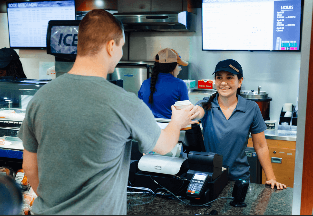 Student employee working a retail stand.